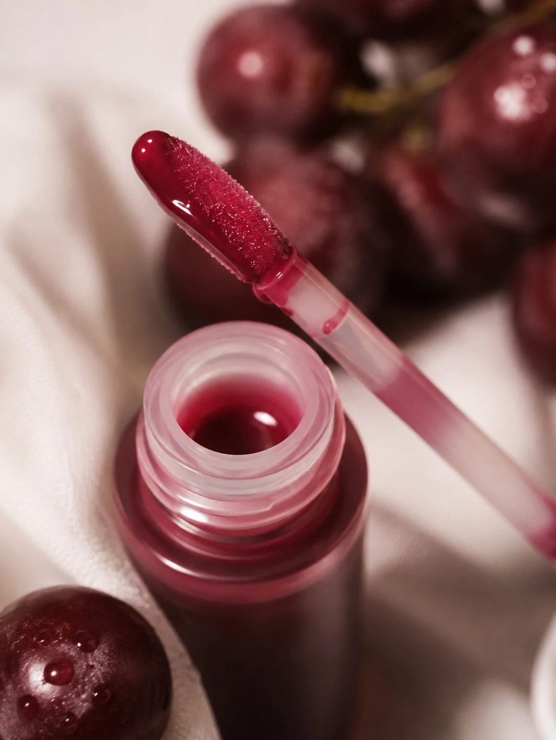 Close-up product photography of a tinted lip oil applicator
