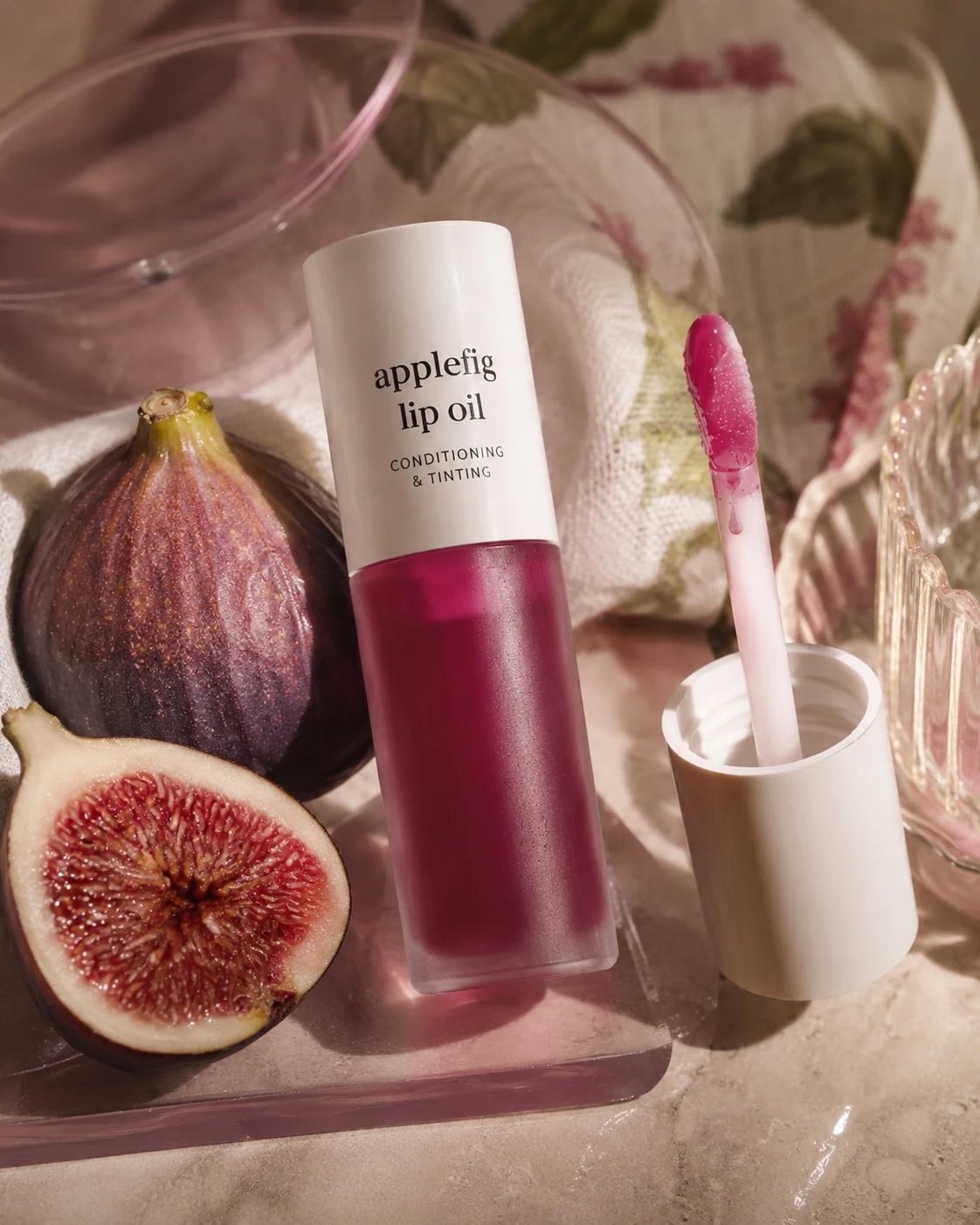 Editorial product photography of tinted lip oil with fresh fig styling